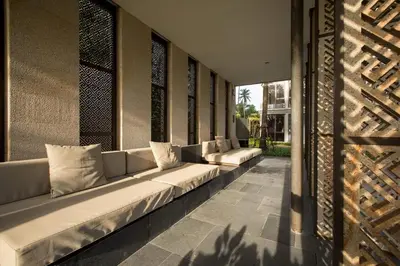 a row of white couches sitting in a building at Baan Mai Khao by Villacarte in Mai Khao Beach