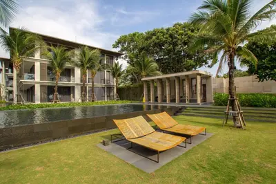 a resort with two chairs and a swimming pool at Baan Mai Khao by Villacarte in Mai Khao Beach