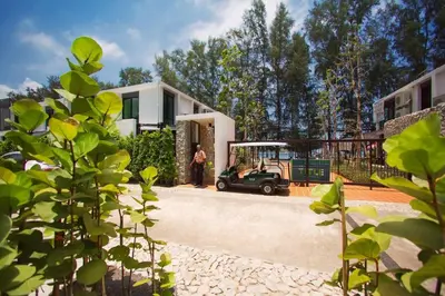 a golf cart parked in front of a house at Title III and II by Villacarte in Rawai Beach