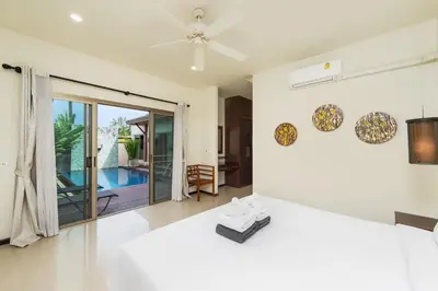 a living room with a ceiling fan and a living room at Villa Ikaroa Private pool villa Kokyang Estate in Nai Harn Beach