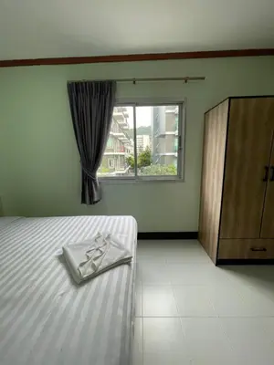 a bedroom with a bed with a towel on it at Omaya GuestHouse in Patong Beach