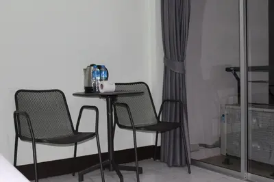 a small table and two chairs in a room at Omaya GuestHouse in Patong Beach