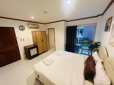 a bedroom with a bed and a tv in it at Omaya GuestHouse in Patong Beach