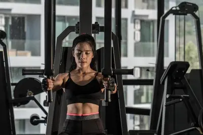 a woman lifting weights in a gym at Kamala D38 Exclusive Junior Suite in Kamala Beach