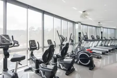 a gym with a row of treadmills and exercise bikes at Kamala D38 Exclusive Junior Suite in Kamala Beach