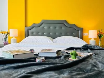 a bedroom with a large bed with a black headboard at Studio room in Mango House in Phuket Town