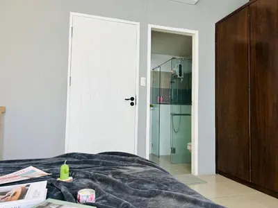 a bedroom with a bed and a bathroom with a shower at Studio room in Mango House in Phuket Town