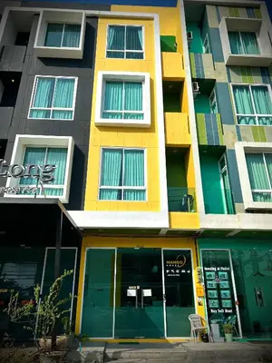 an apartment building with a yellow at Studio room in Mango House in Phuket Town