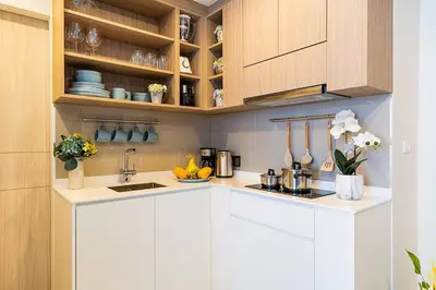 a kitchen with white cabinets and a counter top at Laguna Skypark by My Home Phuket in Bang Tao Beach