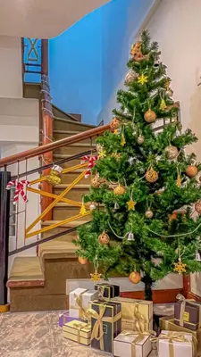 a christmas tree in a room with presents under it at Solene Home Patong in Patong Beach