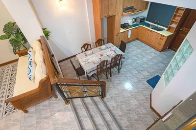 a dining room and kitchen with a table and chairs at Solene Home Patong in Patong Beach