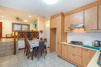 a kitchen with a table and a dining room at Solene Home Patong in Patong Beach