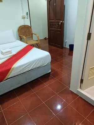 a bedroom with a bed and a tiled floor at Kata S.T House 2 in Phuket Town