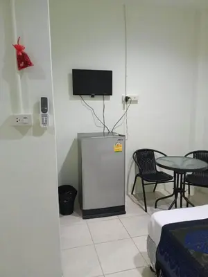 a room with a small refrigerator and a table at Kata S.T House 2 in Phuket Town