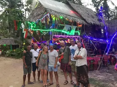 a group of people standing in front of a building with lights at 53ft Sailing Yacht PHUKET Family Sailing adventure in Bang Tao Beach