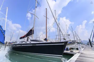 a boat is docked at a dock in the water at 53ft Sailing Yacht PHUKET Family Sailing adventure in Bang Tao Beach