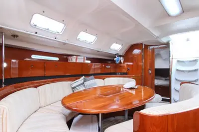 a dining room with a table and white chairs at 53ft Sailing Yacht PHUKET Family Sailing adventure in Bang Tao Beach