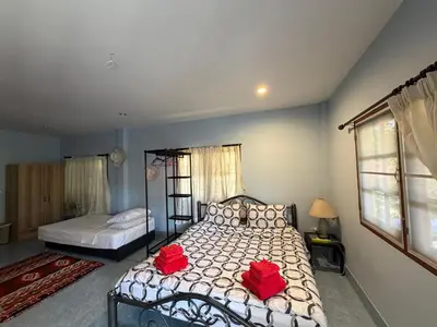 a bedroom with a bed with two red flowers on it at Bohemian apartment at Ya Nui beach in Phuket Town