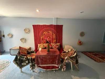 a room with a bed with a red blanket at Bohemian apartment at Ya Nui beach in Phuket Town