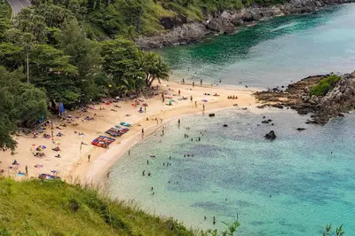 a group of people on a beach in the water at Elephant bungalow at Ya Nui beach in Phuket Town