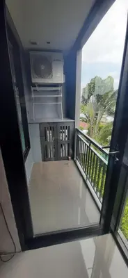 a view from a window of a balcony with a stove at Relife The Windy in Phuket Town