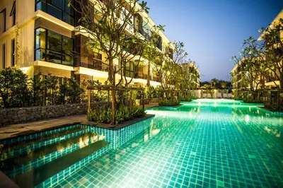 a swimming pool in front of a building at The Title Rawai Beach front 2BD in Rawai Beach