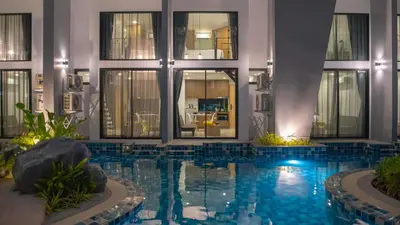 a swimming pool in the middle of a building at Utopia Naiharn in Nai Harn Beach