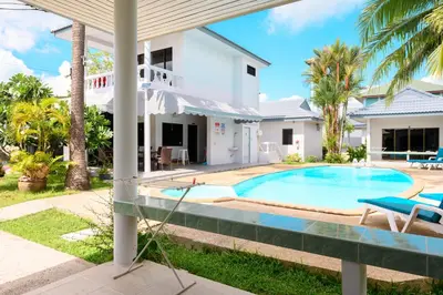 a villa with a swimming pool and a house at Sansuko Ville Panwa in Ban Bo Rae
