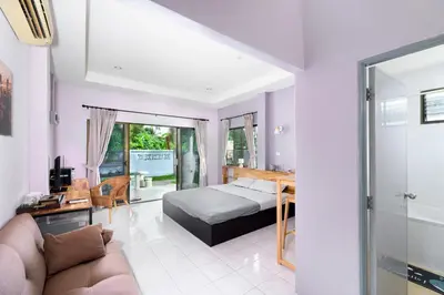 a bedroom with a bed and a couch at Sansuko Ville Panwa in Ban Bo Rae