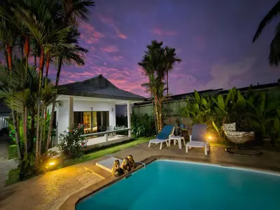 a swimming pool in front of a villa at Sansuko Ville Panwa in Ban Bo Rae