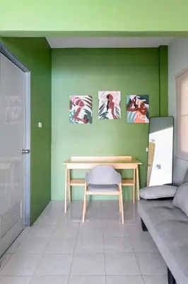 a green room with a table and a bench at Sansuko Ville Panwa in Ban Bo Rae
