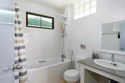 a bathroom with a sink and a toilet and a bath tub at Sansuko Ville Panwa in Ban Bo Rae