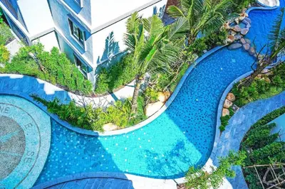 an aerial view of a pool at a resort at TITLE NaiYang apartment-300m from sea in Phuket Town