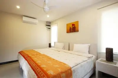 a bedroom with a bed and a painting on the wall at Exotic Boutique 4BR Pool Villa Toya, Gated Residence, Rawai in Rawai Beach