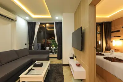 a living room with a couch and a bed at Calypso Garden by Holy Cow, 1-BR, private terrace in Rawai Beach