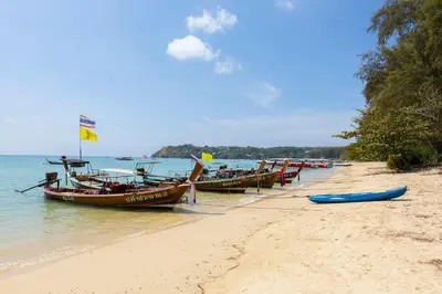 a group of boats sitting on the beach at Calypso Garden by Holy Cow, 1-BR, private terrace in Rawai Beach