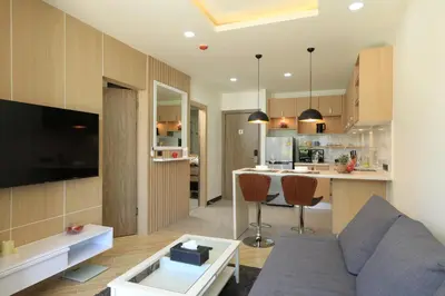 a living room and kitchen with a couch and a table at Calypso Garden by Holy Cow, 1-BR, private terrace in Rawai Beach