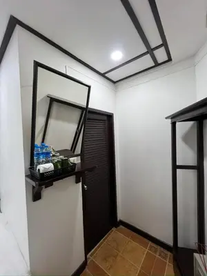 a room with a door with a mirror and a door istg at Relax Guest House in Patong Beach