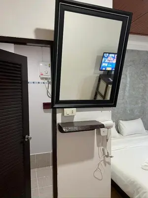 a mirror on a wall in a hotel room at Relax Guest House in Patong Beach