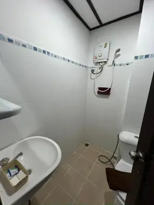 a bathroom with a toilet and a sink at Relax Guest House in Patong Beach