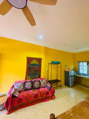 a bedroom with a bed and a ceiling fan at Good vibes bungalow at Ya Nui beach in Phuket Town
