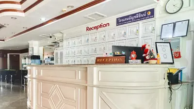 a bar in a restaurant with a clock on the wall at Lime Hotel in Patong Beach