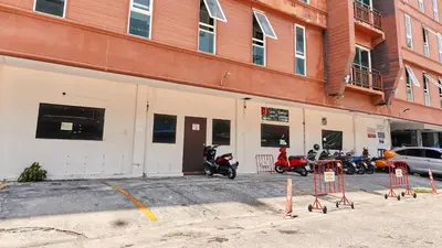 a group of motorcycles parked outside of a building at Lime Hotel in Patong Beach