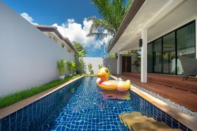 a pool with a rubber duck in the middle of a house at Sanook dream villas Nai Harn Beach in Rawai Beach