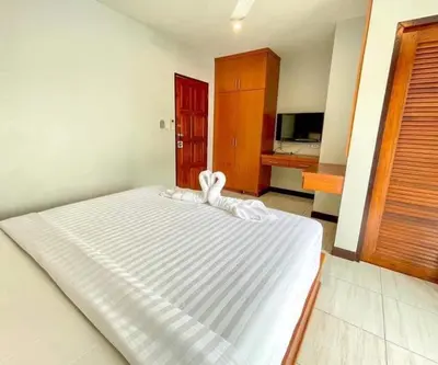 a bedroom with a large white bed in a room at Twenty Two House in Patong Beach