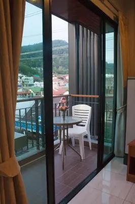 a balcony with a table and chairs and a view at Twenty Two House in Patong Beach