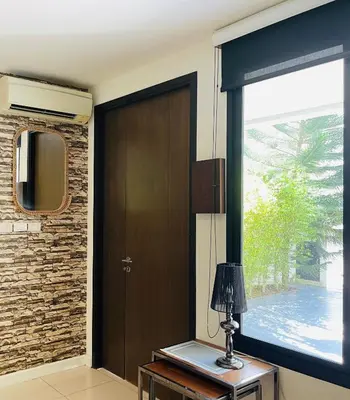 a room with a door and a window and a lamp at Нескучный таунхаус в Лагуне in Phuket Town
