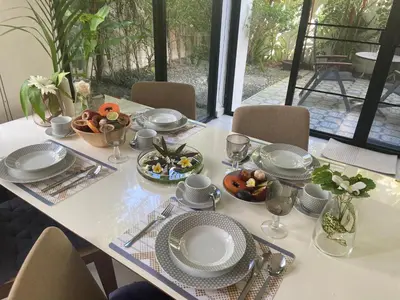 a table with plates and bowls of food on it at Нескучный таунхаус в Лагуне in Phuket Town