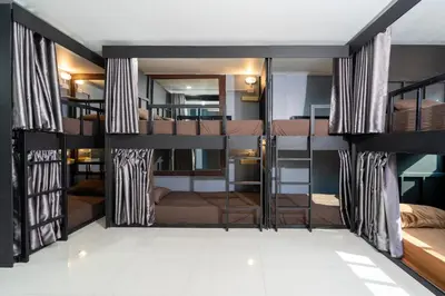a room with several bunk beds in it at Black Pantera Hostel in Patong Beach