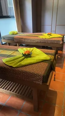 a group of three chairs with yellow napkins on them at Alaita Boutique Phuket in Ban Bo Rae